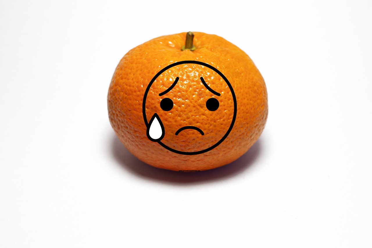 Small orange with overlaid tearful face