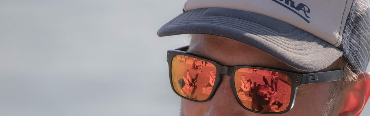 Person wearing mirror shades and cap